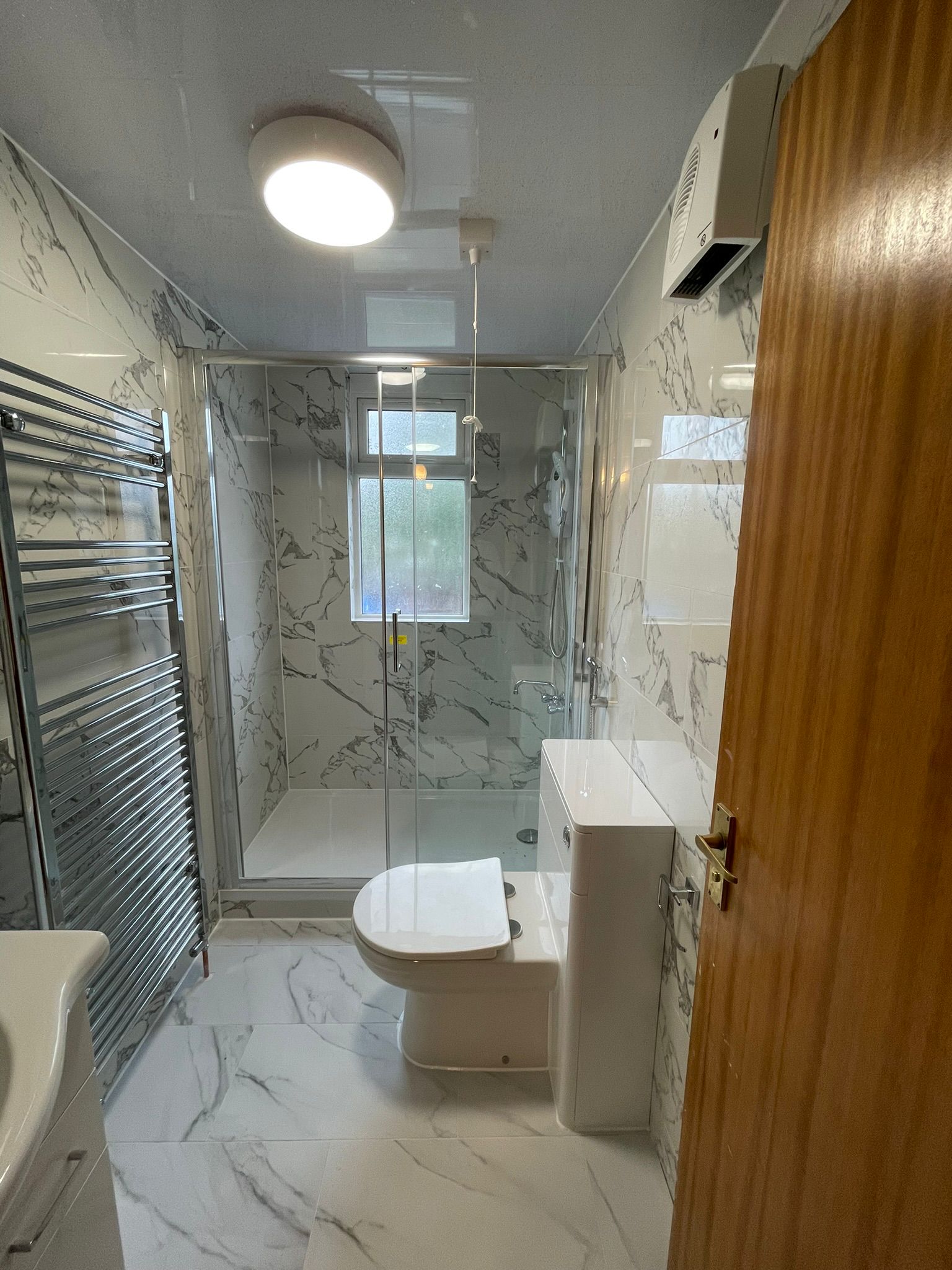 White marble bathroom with heated towel rail