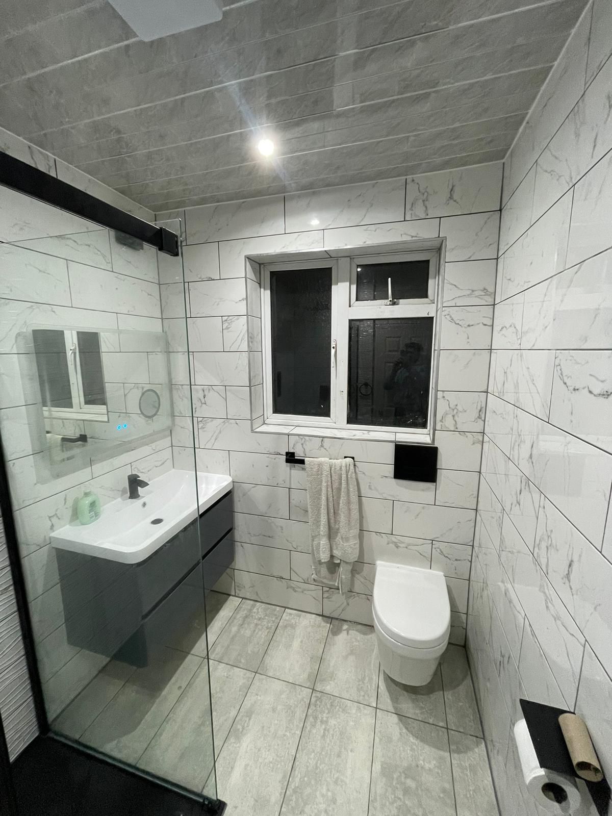 Bathroom with vanity unit and chrome rail